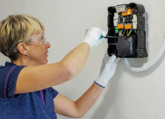 Electrician installing a new outlet with GFCI protection